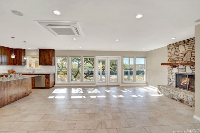 unfurnished living room with a fireplace and light tile patterned floors