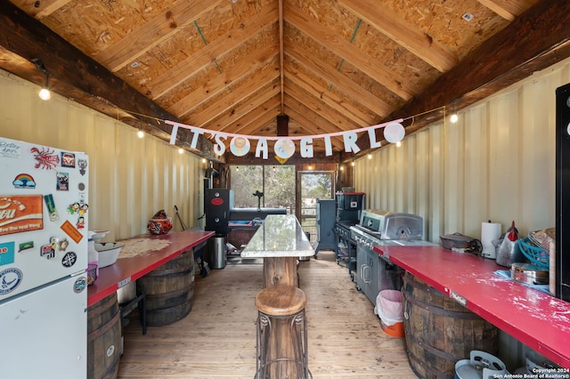 miscellaneous room with hardwood / wood-style floors, beam ceiling, and high vaulted ceiling