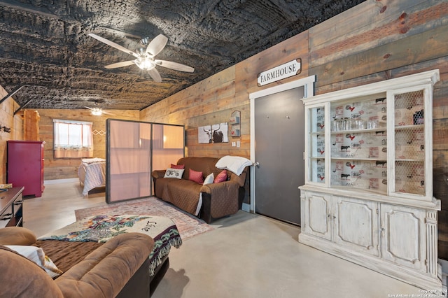 living room featuring wood walls, ceiling fan, and vaulted ceiling