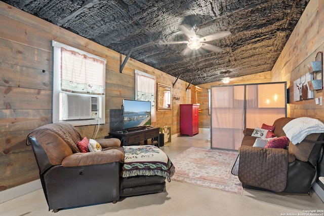 living room with cooling unit, wood walls, ceiling fan, and vaulted ceiling