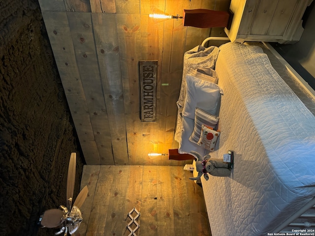 room details featuring wood walls and wood-type flooring