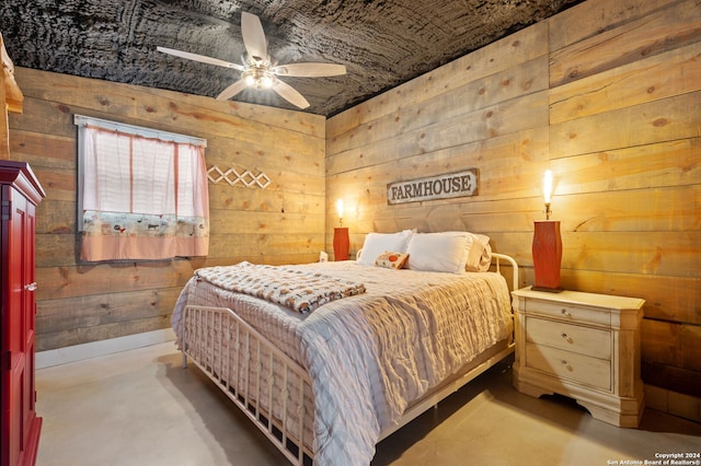 bedroom featuring wooden walls and ceiling fan