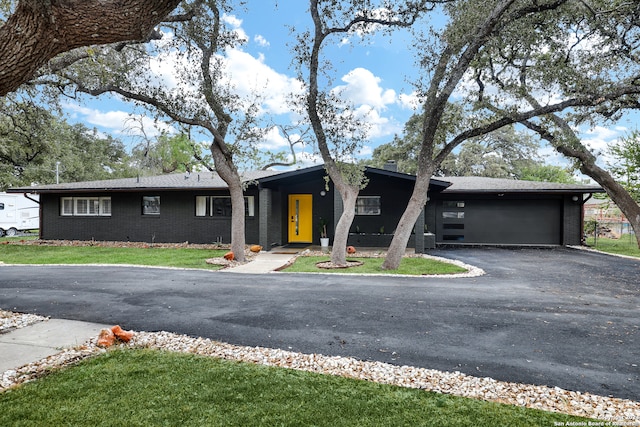 view of front of property with a garage and a front lawn