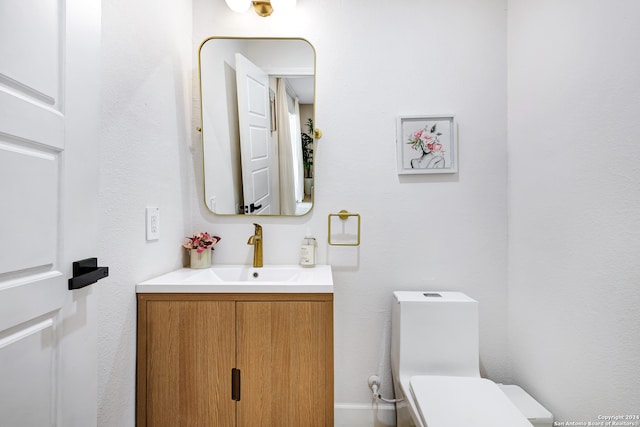 bathroom featuring toilet and vanity