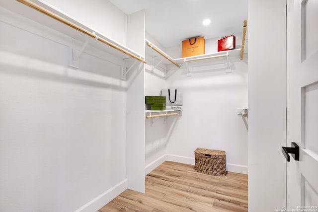 walk in closet with light wood-type flooring