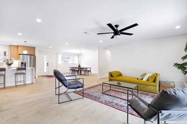 living room with ceiling fan and light hardwood / wood-style floors