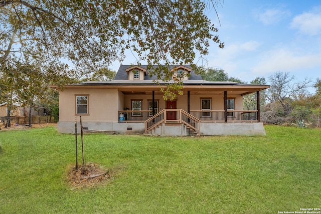 rear view of house featuring a porch and a lawn