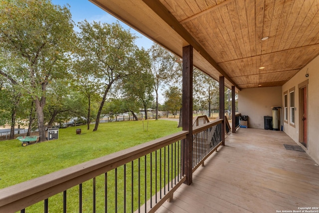 wooden deck featuring a lawn