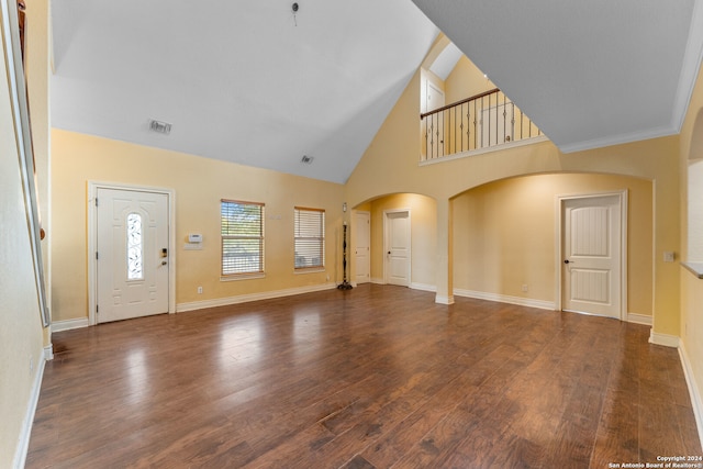 unfurnished living room featuring high vaulted ceiling and dark hardwood / wood-style floors