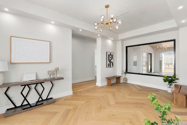 corridor with a notable chandelier and light parquet flooring