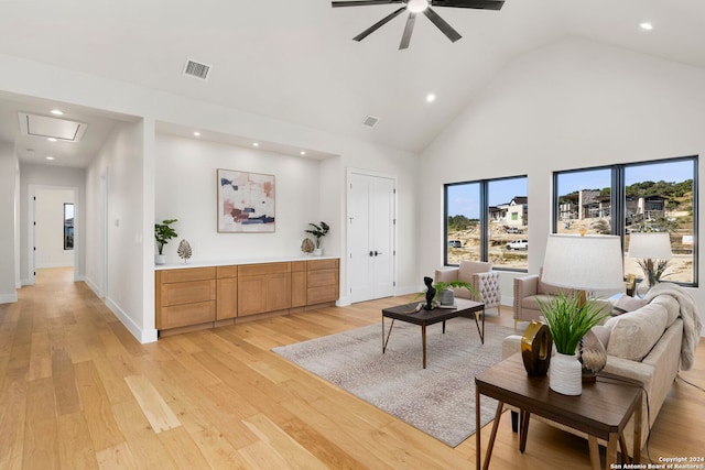 living room featuring high vaulted ceiling, light hardwood / wood-style flooring, and ceiling fan