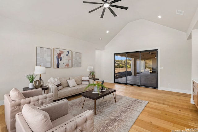 living room with light hardwood / wood-style floors, high vaulted ceiling, and ceiling fan