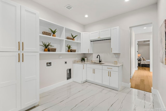 kitchen with white cabinetry and sink