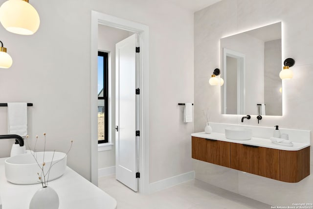 bathroom with tile patterned floors, vanity, and a tub