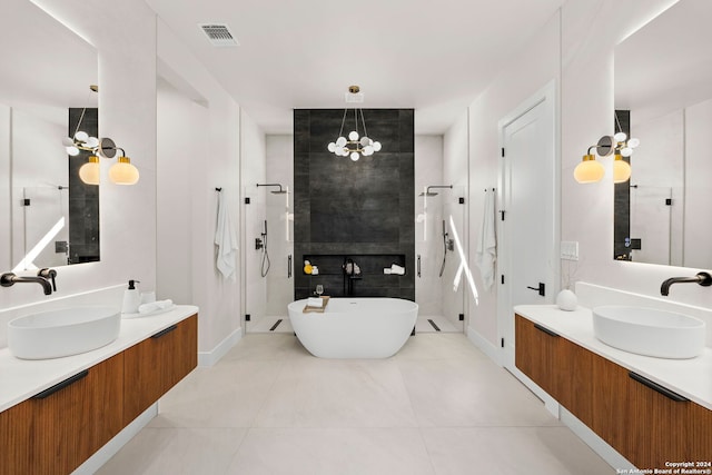 bathroom with tile patterned flooring, vanity, a chandelier, and independent shower and bath