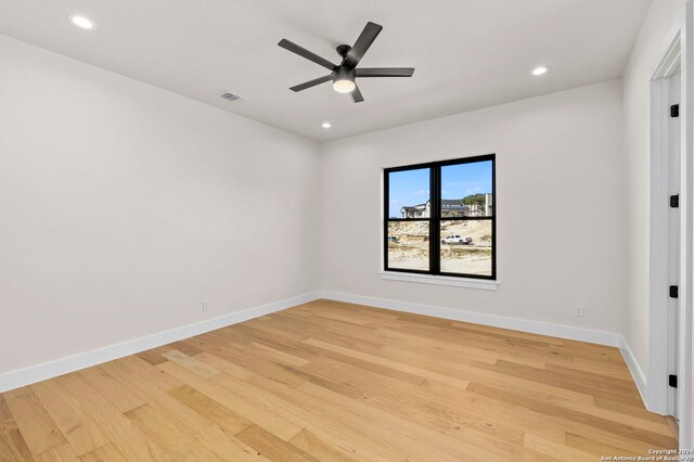 spare room featuring light wood-type flooring and ceiling fan