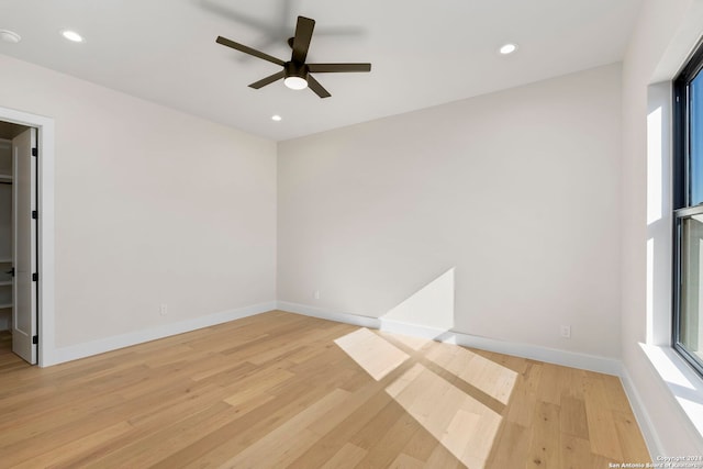 empty room with light hardwood / wood-style floors and ceiling fan