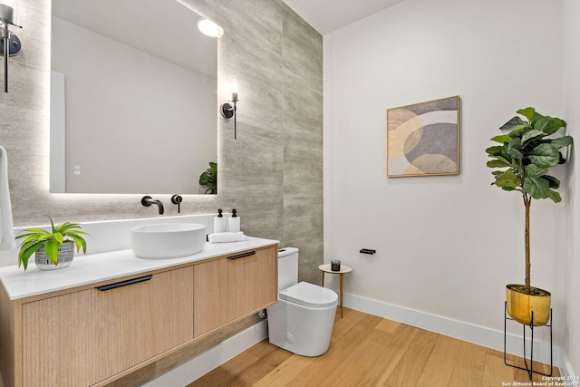 bathroom featuring vanity, toilet, and wood-type flooring