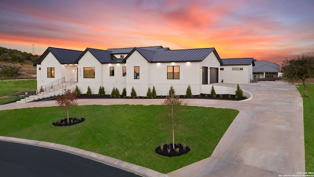 modern inspired farmhouse featuring a lawn