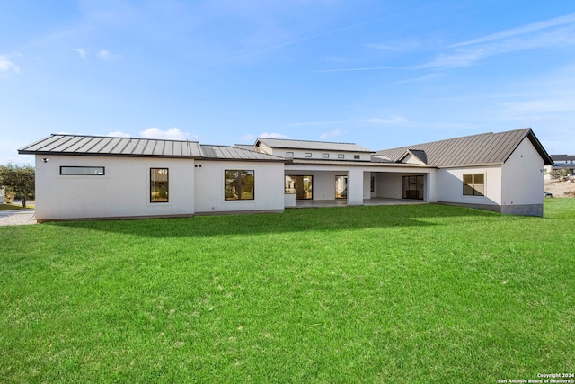 rear view of property with a lawn