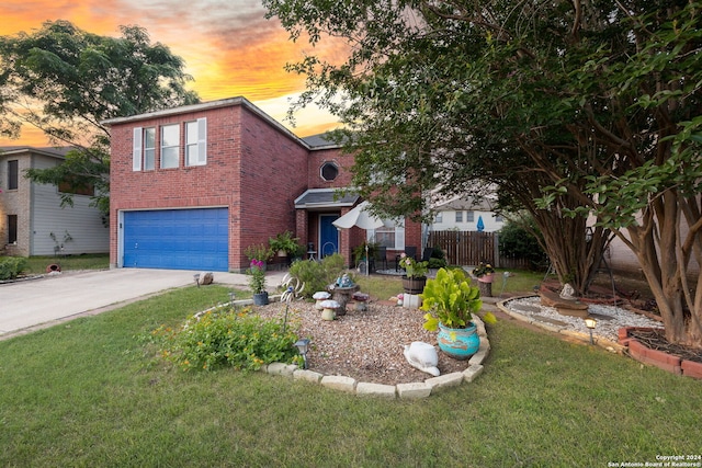 view of front of home featuring a garage and a yard