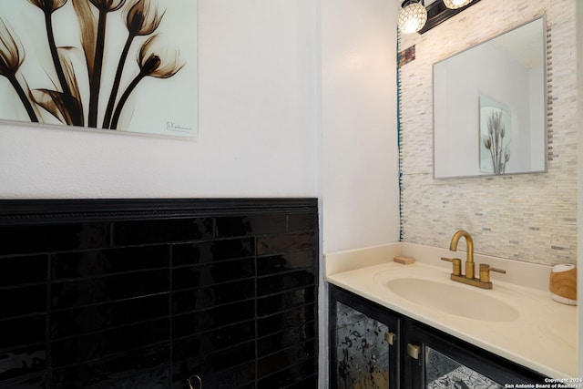 bathroom featuring vanity and tile walls