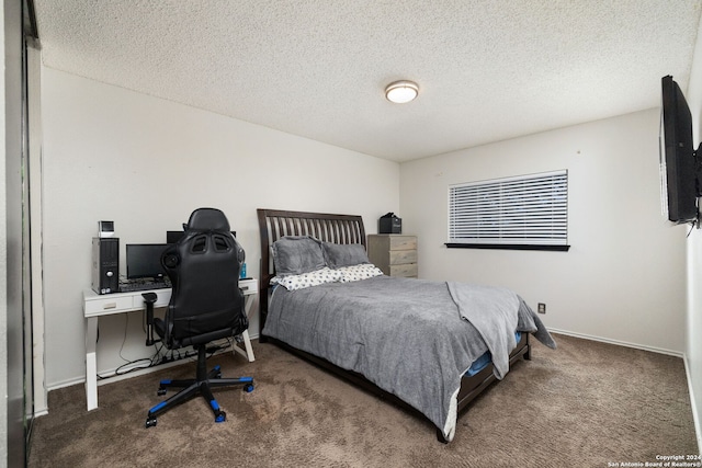 carpeted bedroom featuring a textured ceiling