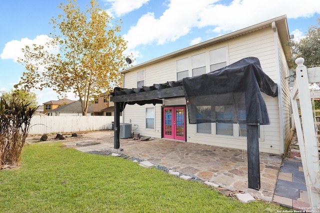 back of house featuring a yard, a patio, and french doors