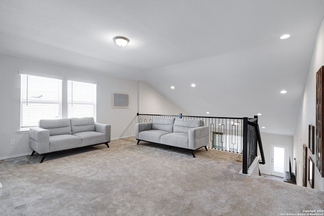 living room with lofted ceiling and light carpet