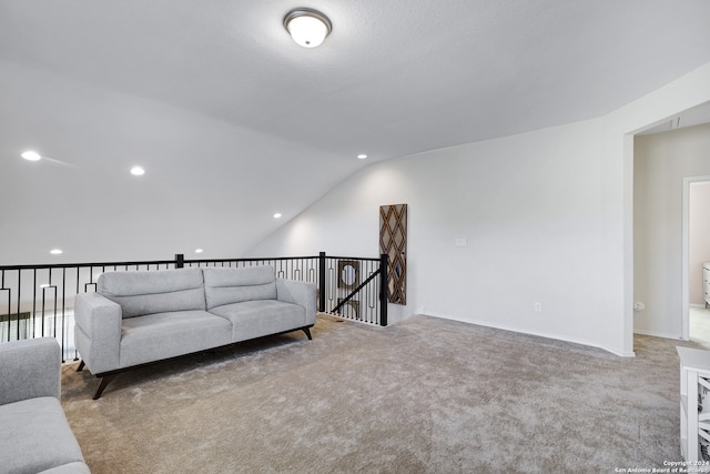 living room featuring vaulted ceiling and light colored carpet