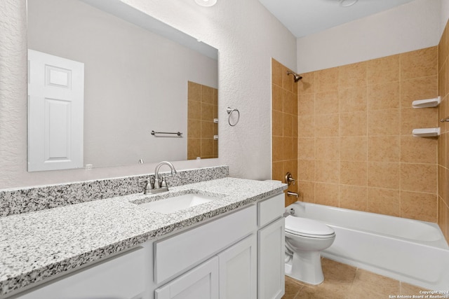 full bathroom with tile patterned floors, vanity, tiled shower / bath combo, and toilet