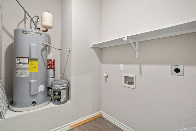 laundry room featuring water heater, hookup for a washing machine, hookup for an electric dryer, and wood-type flooring