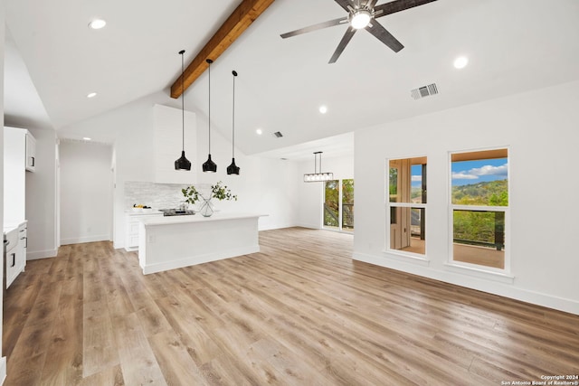 kitchen featuring beamed ceiling, light hardwood / wood-style floors, white cabinetry, and hanging light fixtures