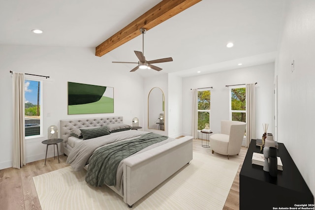 bedroom with vaulted ceiling with beams, ceiling fan, and light hardwood / wood-style flooring