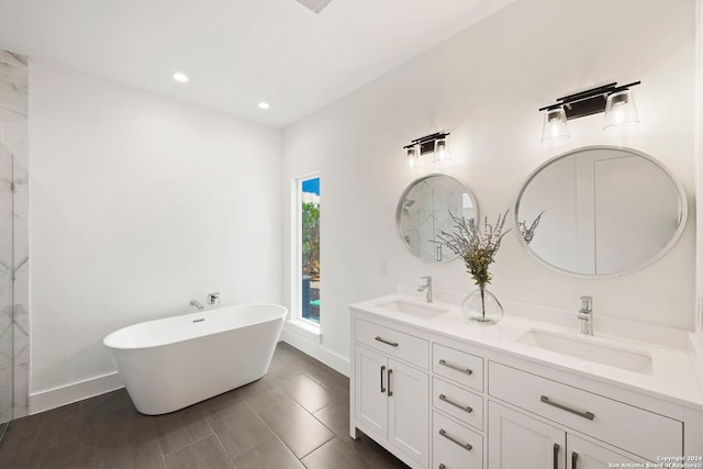 bathroom with a washtub and vanity