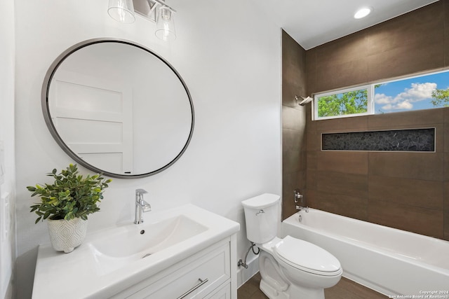 full bathroom featuring vanity, toilet, and tiled shower / bath