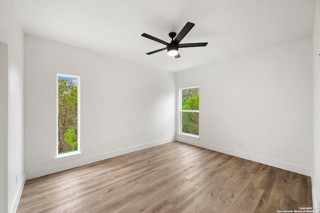 unfurnished room featuring ceiling fan, plenty of natural light, and light hardwood / wood-style flooring