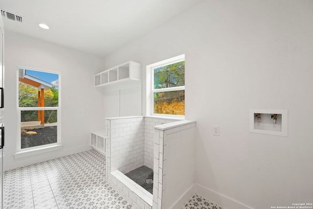 laundry room with hookup for a washing machine and light tile patterned floors