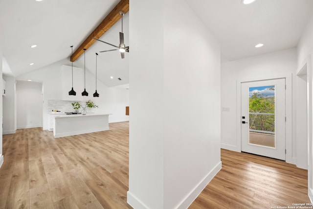 hall featuring lofted ceiling with beams and light hardwood / wood-style flooring