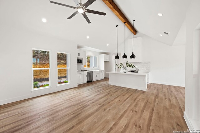 unfurnished living room featuring beam ceiling, ceiling fan, high vaulted ceiling, and light hardwood / wood-style floors