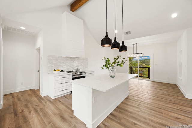 kitchen featuring light wood-type flooring, lofted ceiling with beams, white cabinetry, and hanging light fixtures