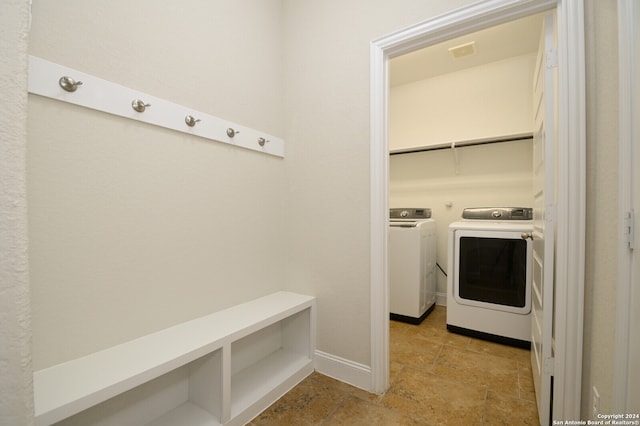 clothes washing area featuring washer and clothes dryer