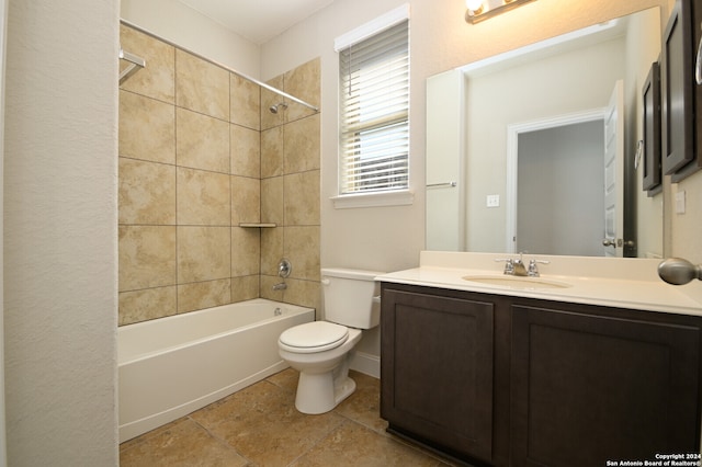 full bathroom with vanity, tile patterned floors, tiled shower / bath, and toilet