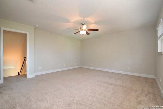 carpeted empty room featuring ceiling fan