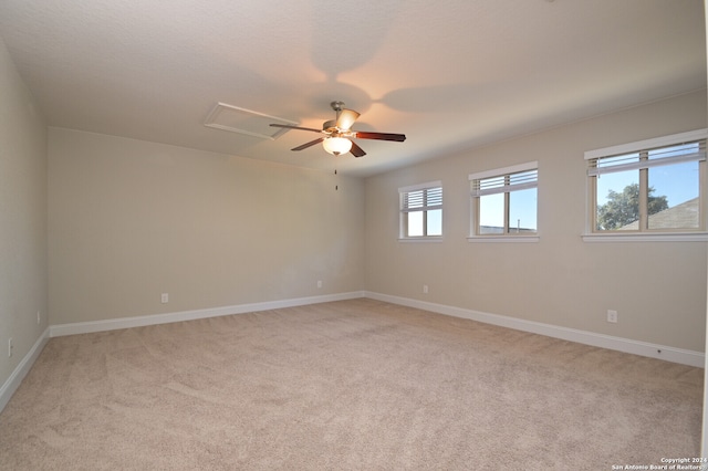 spare room featuring ceiling fan and light colored carpet