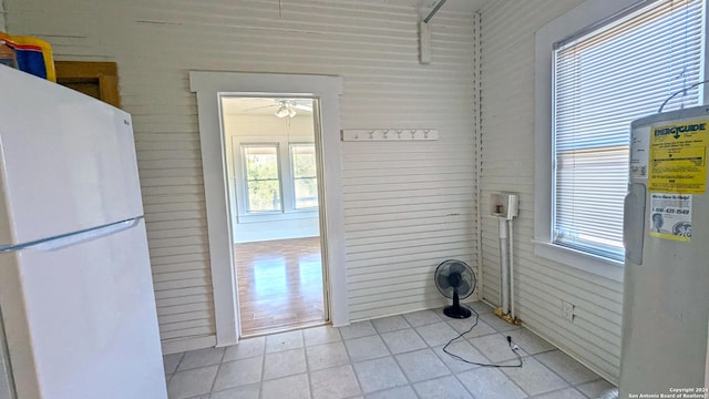 34970AND34900 Smithson Valley Rd, Bulverde, TX 78163 - doorway with healthy amount of natural light, ceiling fan, water heater, and light tile patterned flooring