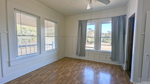 34970AND34900 Smithson Valley Rd, Bulverde, TX 78163 - spare room featuring dark wood-style flooring, plenty of natural light, a ceiling fan, and a wainscoted wall