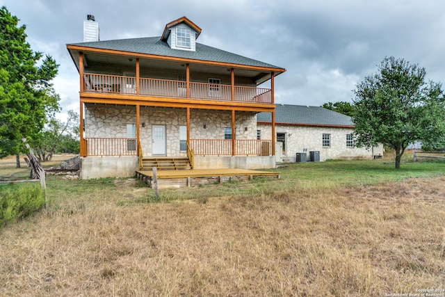 34970AND34900 Smithson Valley Rd, Bulverde, TX 78163 - back of property with stone siding, a chimney, a balcony, and a yard