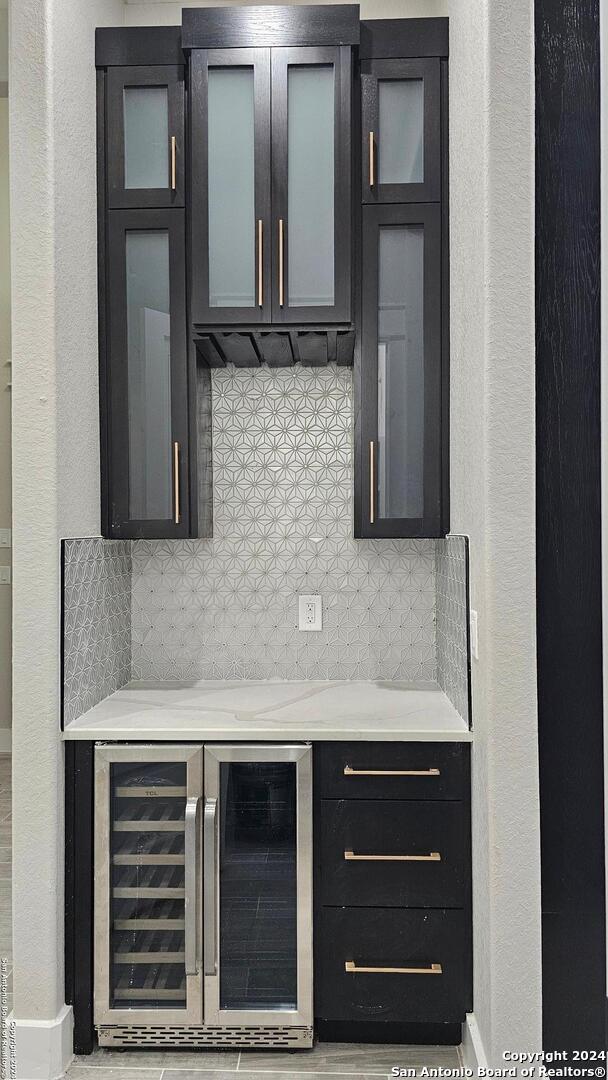 kitchen with decorative backsplash and beverage cooler