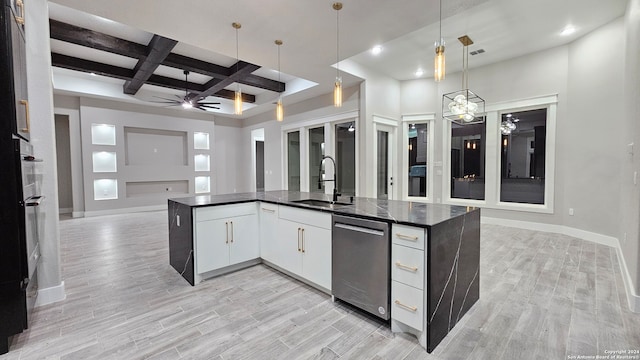 kitchen featuring pendant lighting, white cabinets, sink, light hardwood / wood-style flooring, and stainless steel dishwasher